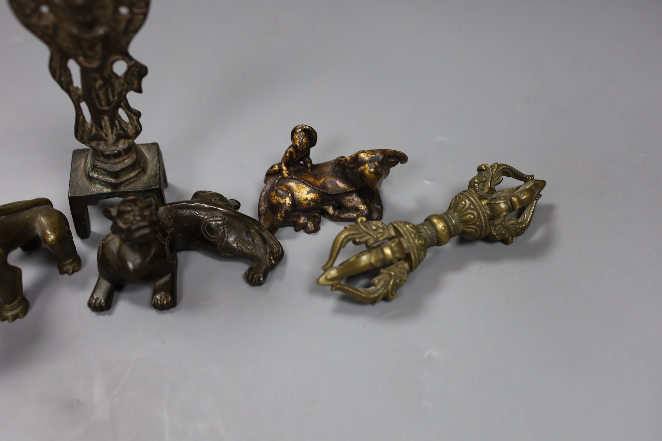 Five Chinese or Tibetan bronze figures or Buddhist implements, tallest 13cms high
